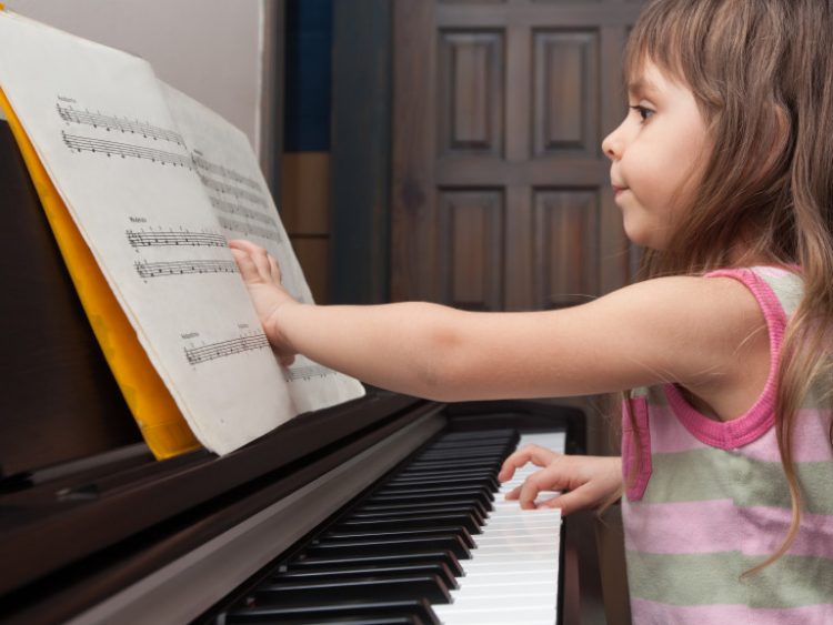Little girl playing the piano