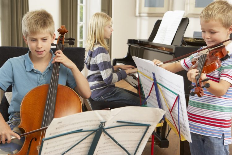 Children playing musical instruments at home