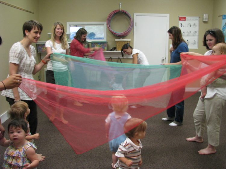 parents and babies playing