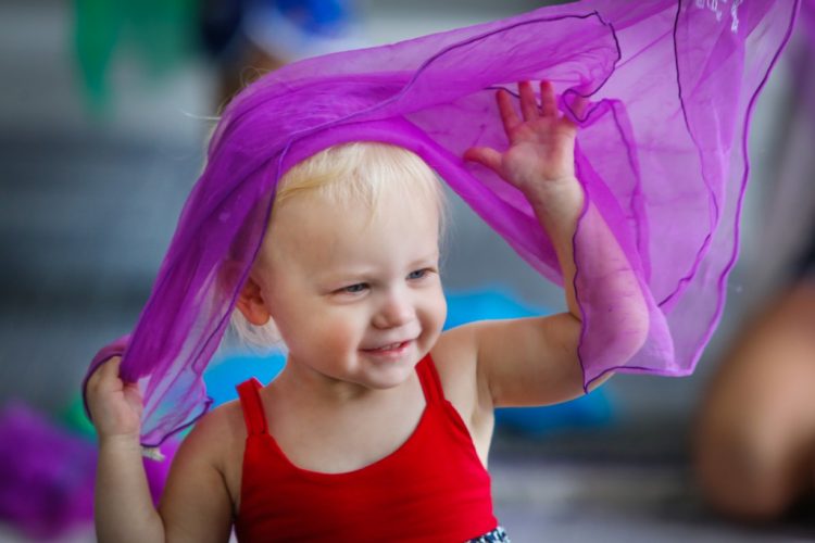 toddler with a purple scarf