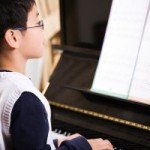 asian kid playing piano