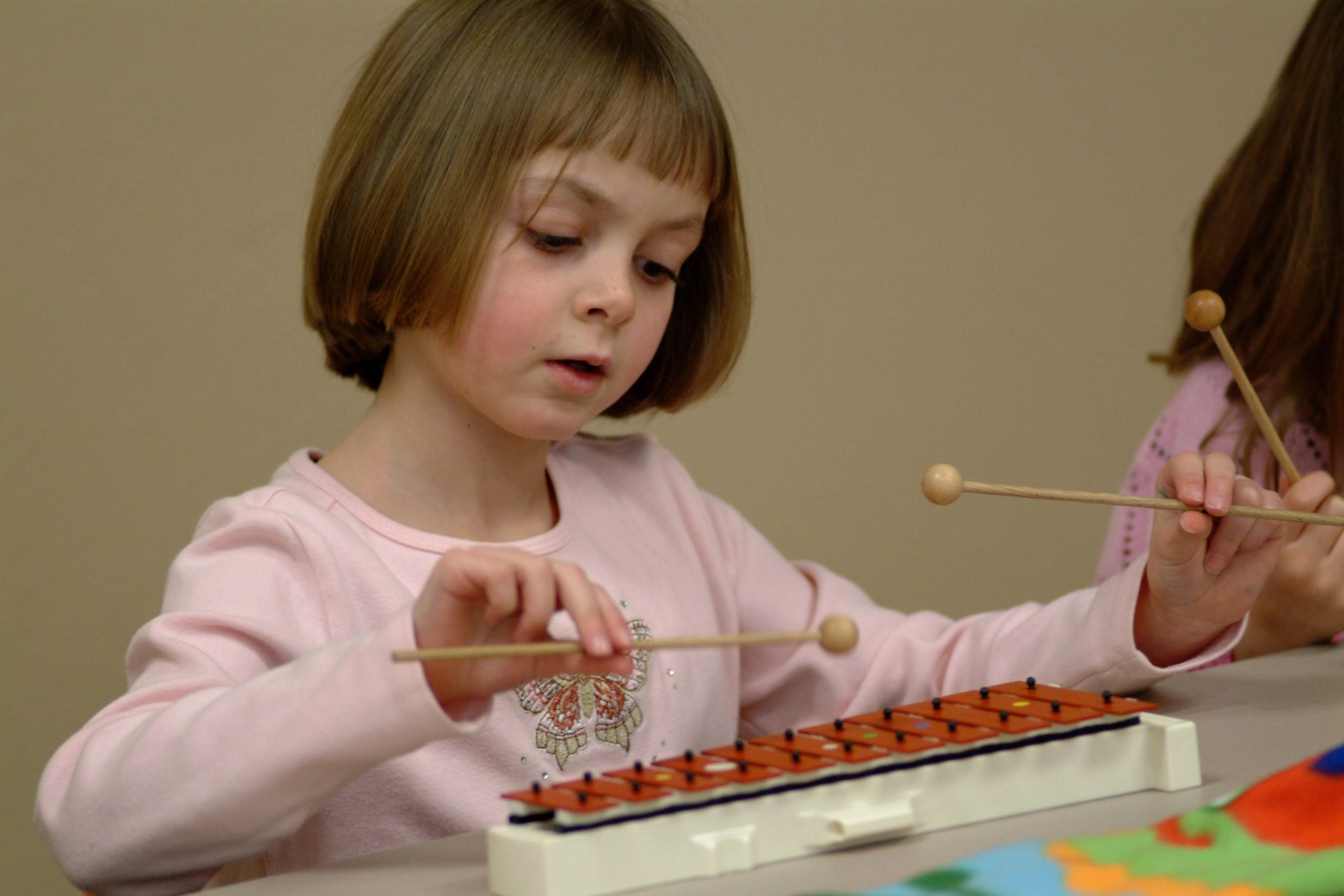 young girl playing xylophone