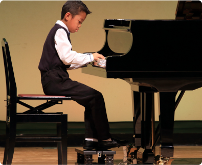 young kid playing a piano