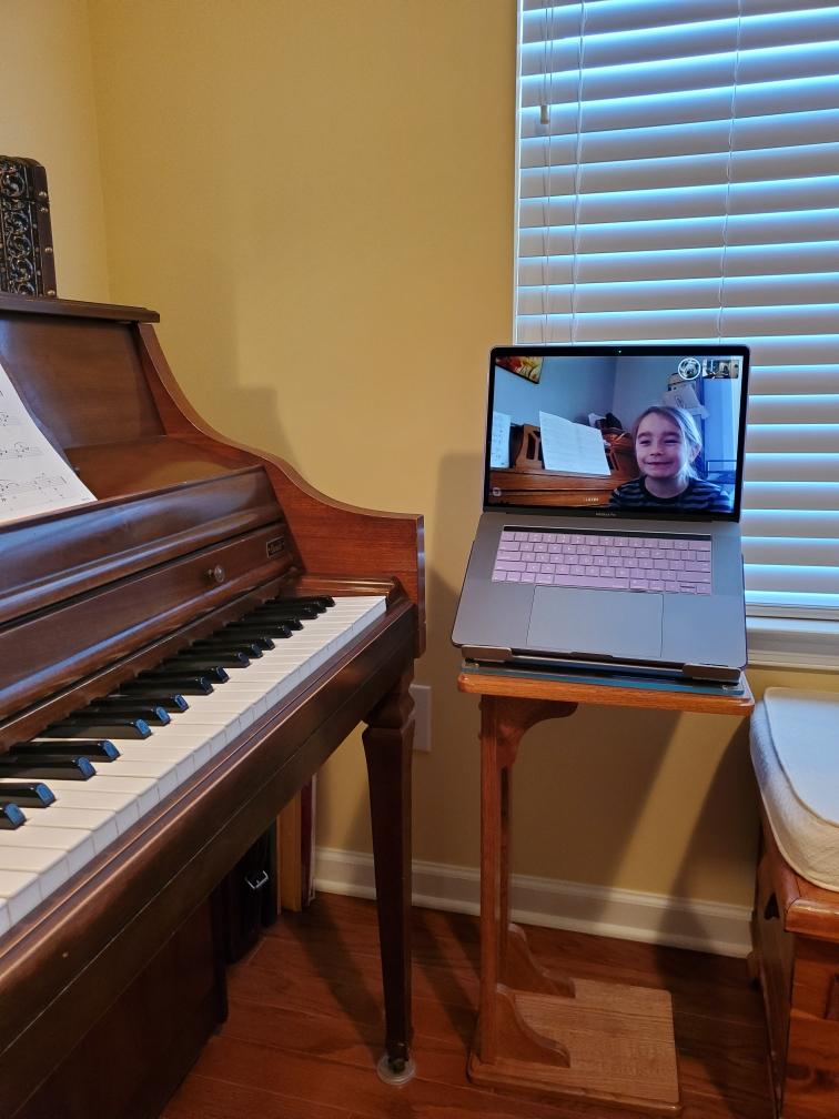 young girl taking online music lessons