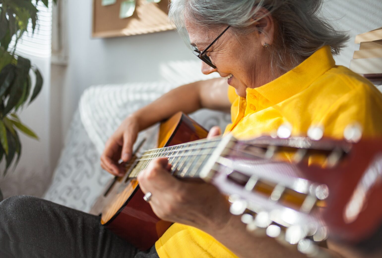 mature woman playing the guitar