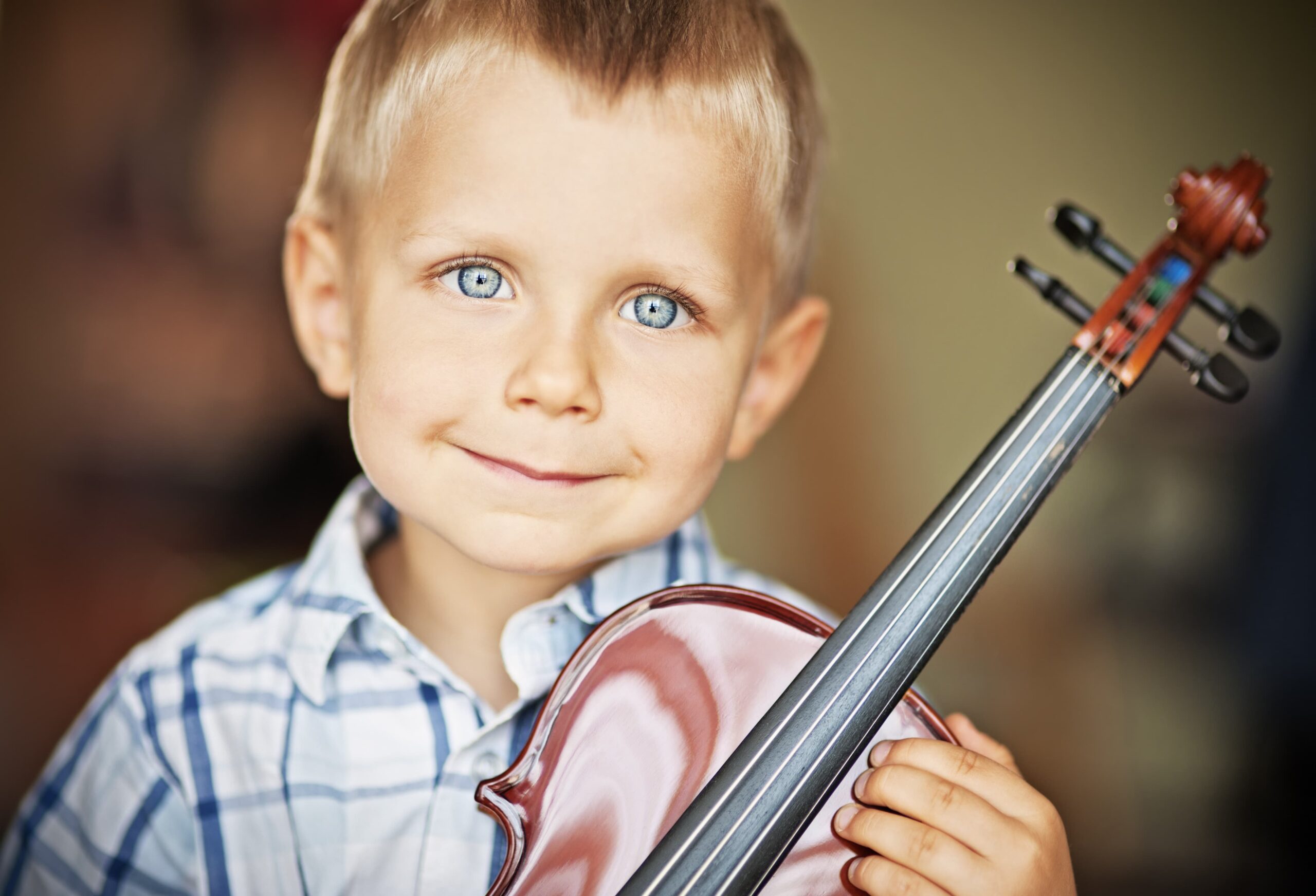 child holding a small violin