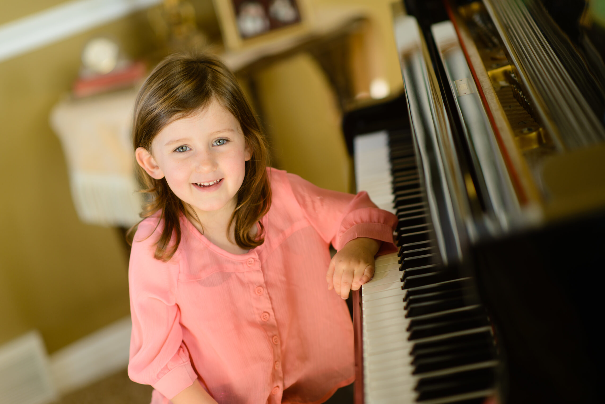 girl sitting at a piano