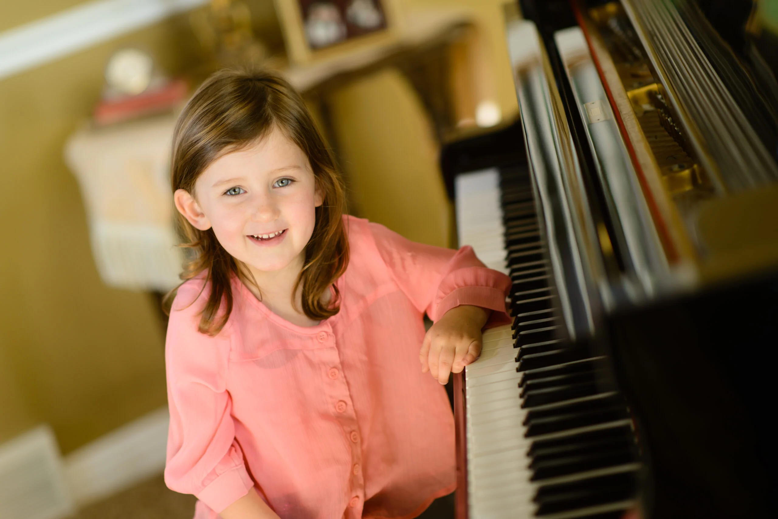 girl sitting at a piano